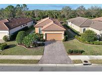 Beautiful single-story home featuring a brick paved driveway and a well-manicured lawn at 5020 Savona Run, Bradenton, FL 34211