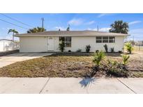 Charming single-story home with a white exterior, well-maintained landscaping, and a sunny curb appeal at 6211 Cornell Rd, Bradenton, FL 34207