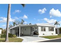 Charming home featuring an awning-covered carport for convenient parking and protection from the elements at 3219 Aspen Ter, Sarasota, FL 34237