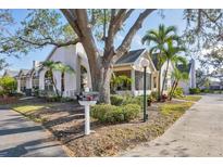 Charming home with lush landscaping, mature trees, and a welcoming screened-in porch at 4563 Whirlaway Dr # C, Sarasota, FL 34233