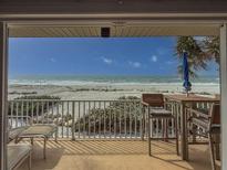 Enjoy the beach view from this cozy balcony with comfortable seating and ocean breezes at 6701 Gulf Of Mexico Dr # 311, Longboat Key, FL 34228