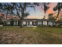 Charming brick home featuring a well-manicured lawn and mature trees at 1521 67Th Street E Ct, Bradenton, FL 34208