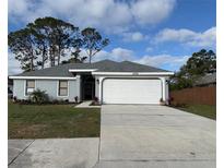 Charming single-story home with well-maintained landscaping and attached two-car garage at 1839 Wood Hollow Cir, Sarasota, FL 34235