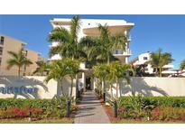 Beautiful condo exterior with manicured landscaping and walkway leading to the entrance at 6512 Midnight Pass Rd # 206, Sarasota, FL 34242