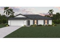 Charming single-story home featuring a well-manicured lawn, two-car garage, and welcoming front entrance at 16275 Banyan Ave, Port Charlotte, FL 33954