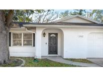 Inviting front door with an archway and modern black hardware at 2312 Java Plum Ave, Sarasota, FL 34232