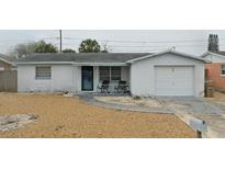 Quaint single-story home with an attached garage and a small front porch area at 3544 Brompton Dr, Holiday, FL 34691