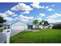 Charming single-story home featuring a well-manicured lawn and nicely landscaped front yard at 6513 14Th W Ave, Bradenton, FL 34209