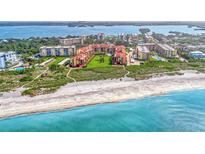 Aerial view of beachfront condo community with lush landscaping and pool at 8750 Midnight Pass Rd # 202, Sarasota, FL 34242