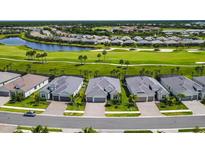 Aerial view of luxury homes with golf course and lake views at 25133 Longmeadow Dr, Punta Gorda, FL 33955