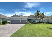 Charming home with a well-manicured front yard, palm trees, and a spacious three-car garage at 15240 Spanish Point Dr, Port Charlotte, FL 33981