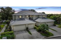 Attractive three-unit building, featuring attached garages and lush landscaping at 3332 Grand Vista Ct # 101, Port Charlotte, FL 33953