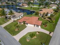 Aerial view of single-Gathering home with canal access and lush landscaping at 442 Macedonia Dr, Punta Gorda, FL 33950