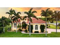 Luxury home with terracotta roof and palm trees at 24087 Santa Inez Rd, Punta Gorda, FL 33955