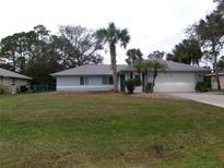 Single-story house with a large yard and palm trees at 2931 S Cranberry Blvd, North Port, FL 34286