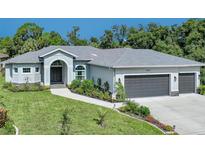 Beautiful single Gathering home featuring an attached two car garage and manicured landscaping at 4767 Maurbach Ter, North Port, FL 34286