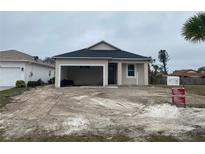 Newly constructed one-story home with attached garage and partial landscaping at 4250 Oak Terrace Cir, Port Charlotte, FL 33953