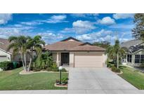 One-story home with attached garage, landscaping, and a spacious driveway at 632 Rose Apple Cir, Port Charlotte, FL 33954