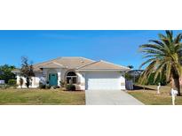 Single-story home with tile roof, white exterior, and landscaped lawn at 831 Via Tunis, Punta Gorda, FL 33950