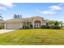 One-story home with attached garage, and nicely landscaped lawn at 219 White Marsh Ln, Rotonda West, FL 33947