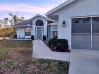 Single-story home with attached garage and landscaped front yard at 4317 Eldron Ave, North Port, FL 34286