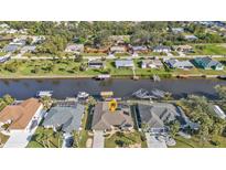 Aerial view of canal-front home with private dock and boat lift at 18491 Hottelet Cir, Port Charlotte, FL 33948