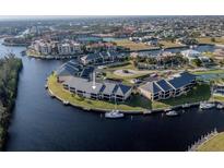 Aerial view of waterfront community with tennis courts and boat slips at 3256 White Ibis Ct # 22A, Punta Gorda, FL 33950