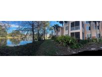 Scenic view of a condo community with a serene lake and lush landscaping on a sunny day at 4178 Central Sarasota Pkwy # 326, Sarasota, FL 34238