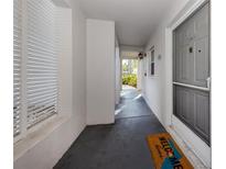 Inviting condo entryway with gray door and welcome mat at 437 Cerromar Ln # 312, Venice, FL 34293