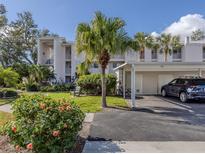 Two-story condo building with parking and lush landscaping at 437 Cerromar Ln # 312, Venice, FL 34293