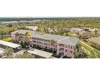 Aerial view of condo building, parking, and landscaping at 2061 Willow Hammock Cir # 204, Punta Gorda, FL 33983