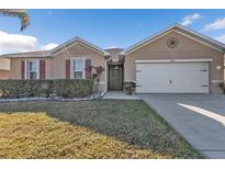 One-story home with attached garage, landscaped lawn, and a neutral color palette at 25017 Lalique Pl, Punta Gorda, FL 33950