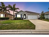 One-story home with a two-car garage and landscaped lawn at 7021 Waterford Pkwy, Punta Gorda, FL 33950