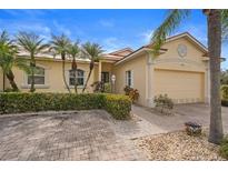 Beautiful stucco home with lush landscaping and a paved driveway at 1531 Aqui Esta Dr # 1, Punta Gorda, FL 33950