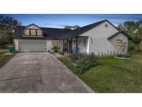 Charming mid-century modern home with updated exterior and landscaping at 1573 Faraday St, Port Charlotte, FL 33952