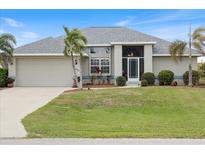 Single-story house with attached garage and landscaped lawn at 16253 Cape Horn Blvd, Punta Gorda, FL 33955