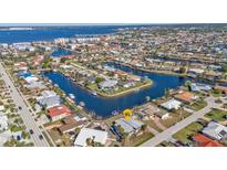 Aerial view showcasing waterfront home with private dock and canal access at 1640 Montia Ct, Punta Gorda, FL 33950