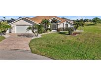 Single-story home with attached garage and landscaped lawn at 2210 Bengal Ct, Punta Gorda, FL 33983