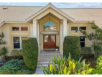 Elegant entryway with double doors and landscaping at 2427 St Davids Island Ct, Punta Gorda, FL 33950