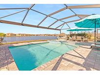 Resort-style pool with covered lanai overlooking lake at 25361 E Lenox Cir, Punta Gorda, FL 33950