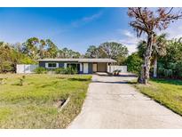 Gray house with a white fence and driveway at 3214 Amanda St, Punta Gorda, FL 33950