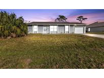 Newly renovated single-story home with a well-manicured lawn at 3450 Moravia Ave, North Port, FL 34286