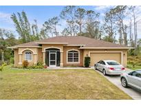 One-story home with a screened porch and two-car garage at 4258 Mermell Cir, North Port, FL 34291