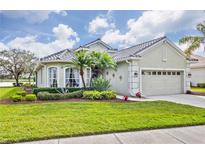 Single-story house with a two-car garage and well-manicured lawn at 5752 Whispering Oaks Dr., North Port, FL 34287