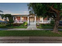 Charming two-story home with a wrap-around porch and landscaped yard at 668 W Olympia Ave, Punta Gorda, FL 33950