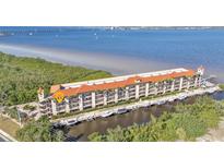 Aerial view of waterfront condo building with boat slips and amazing water access at 900 E Marion Ave # 1301, Punta Gorda, FL 33950