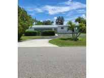 Charming single story home with a spacious lawn and driveway at 158 Concord Ne Dr, Port Charlotte, FL 33952