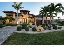 Luxury home with Mediterranean styling, manicured landscaping, and a brick driveway at 2521 Rio Grande Dr, Punta Gorda, FL 33950