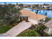 Single-story home with canal views, two-car garage, and landscaped yard at 2856 Deborah Dr, Punta Gorda, FL 33950