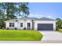 Single-story home with gray roof, white walls, and stone accents at 4024 Feather Ter, North Port, FL 34286